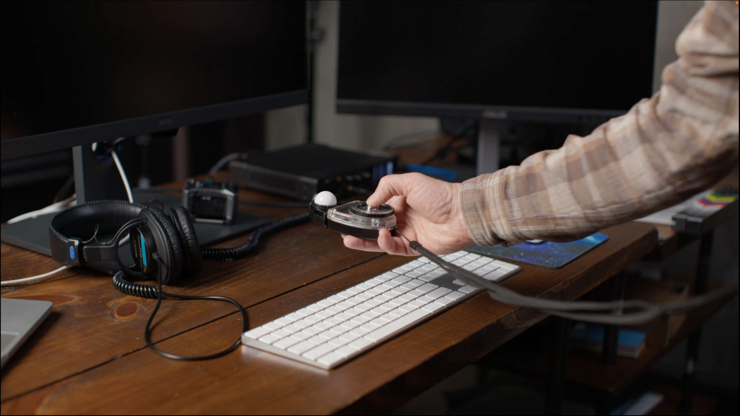 Use a light meter to measure control surface brightness in a grading suite.